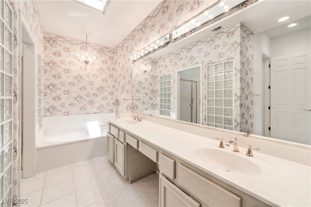 2404 Spring Water Drive Las Vegas, NV 89134 - Photo 22 of 27 Bathroom with double vanity, a bath, a shower stall, wallpapered walls, and tile patterned flooring