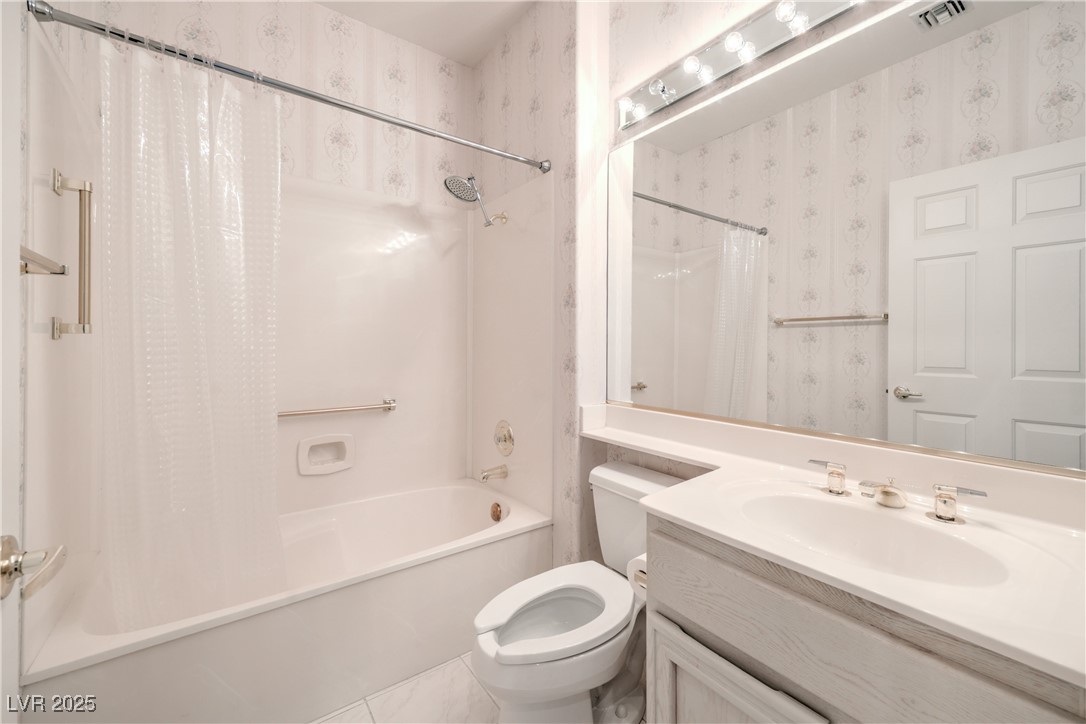 2404 Spring Water Drive Las Vegas, NV 89134 - Photo 23 of 27 Full bath with wallpapered walls, shower / bath combo, and vanity
