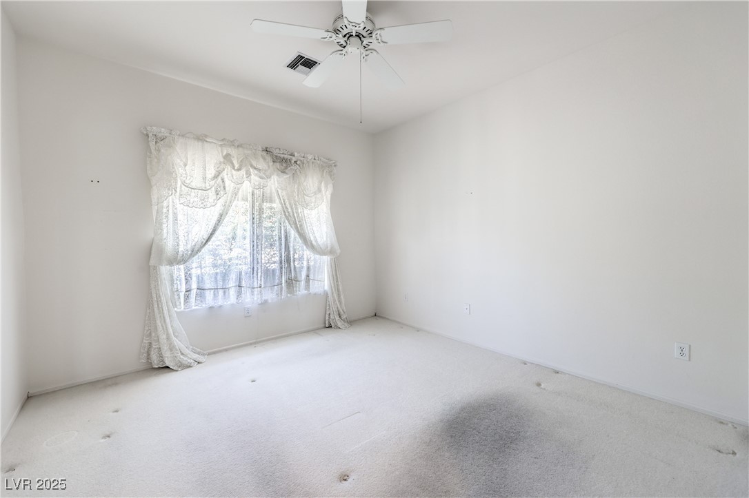 2404 Spring Water Drive Las Vegas, NV 89134 - Photo 27 of 27 Spare room with carpet flooring and ceiling fan