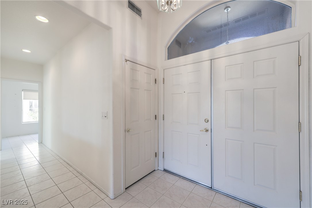 2404 Spring Water Drive Las Vegas, NV 89134 - Photo 3 of 27 Foyer with light tile patterned flooring and recessed lighting