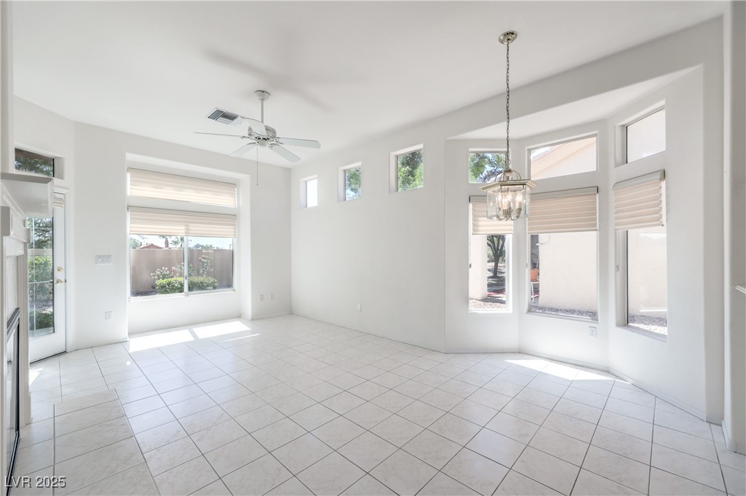 2404 Spring Water Drive Las Vegas, NV 89134 - Photo 9 of 27 Kitchen/family room featuring a chandelier, light tile patterned floors, and ceiling fan