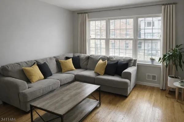 a living room with furniture and a large window