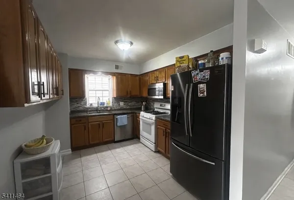 a kitchen with granite countertop stainless steel appliances and counter space