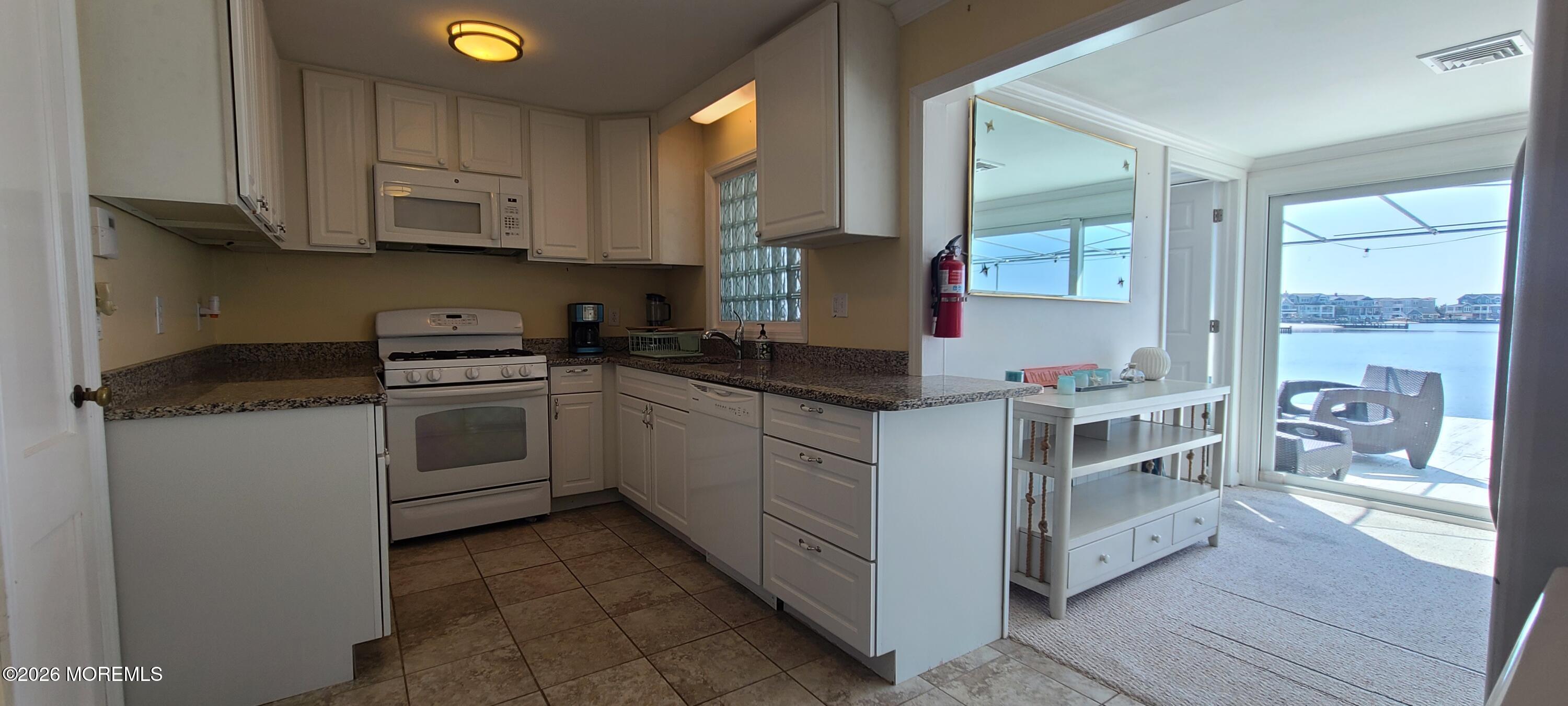 259 Joseph Street Lavallette, NJ 08735 - Photo 19 of 26 a kitchen with a white cabinets and white appliances