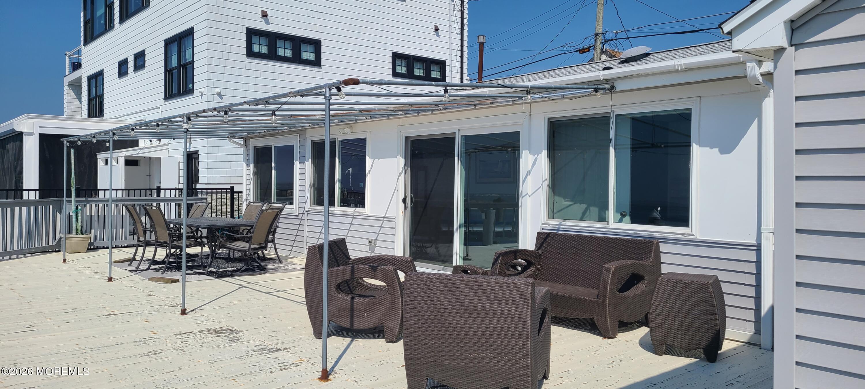 259 Joseph Street Lavallette, NJ 08735 - Photo 2 of 26 a view of a patio with couches table and chairs and potted plants