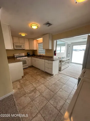 a kitchen with a sink cabinets and window