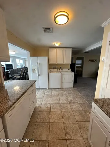 a large kitchen with a stove a sink dishwasher and a refrigerator