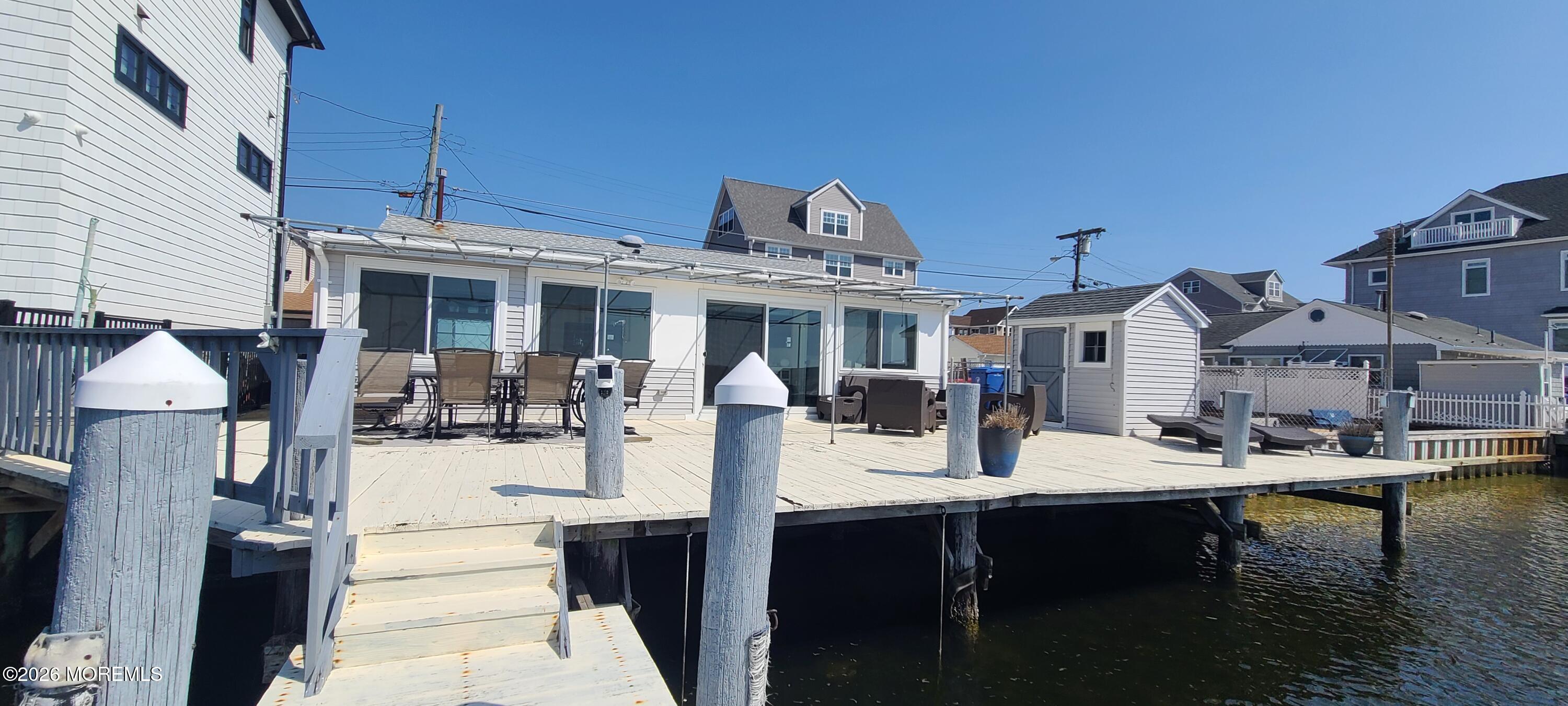 259 Joseph Street Lavallette, NJ 08735 - Photo 4 of 26 a view of a patio with dining table and chairs with a table and chairs