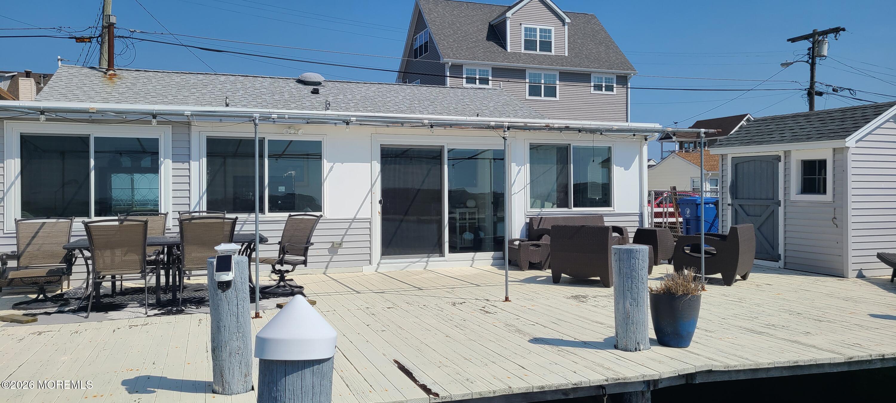 259 Joseph Street Lavallette, NJ 08735 - Photo 6 of 26 a view of a patio with couches table and chairs and potted plants