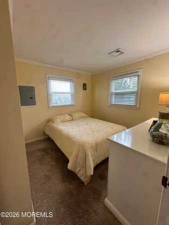 a spacious bedroom with a bed and window