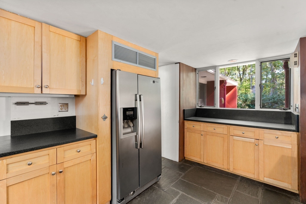 60 Baker Bridge Road Lincoln, MA 01773 - Photo 11 of 38 a kitchen with stainless steel appliances a refrigerator sink and cabinets