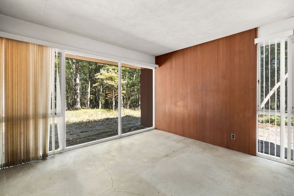 60 Baker Bridge Road Lincoln, MA 01773 - Photo 13 of 38 an empty room with wooden floor and windows