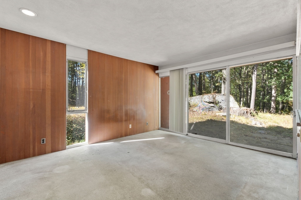 60 Baker Bridge Road Lincoln, MA 01773 - Photo 14 of 38 a view of an empty room with wooden floor and a window