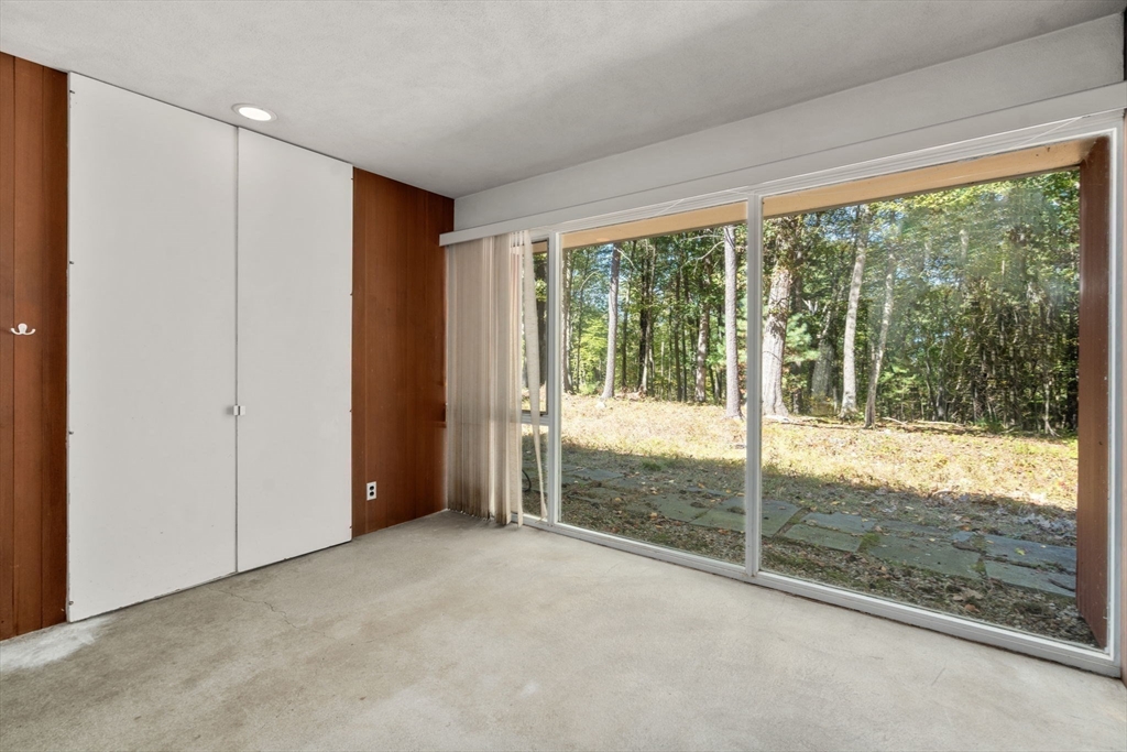 60 Baker Bridge Road Lincoln, MA 01773 - Photo 23 of 38 a view of an empty room with wooden floor and a balcony