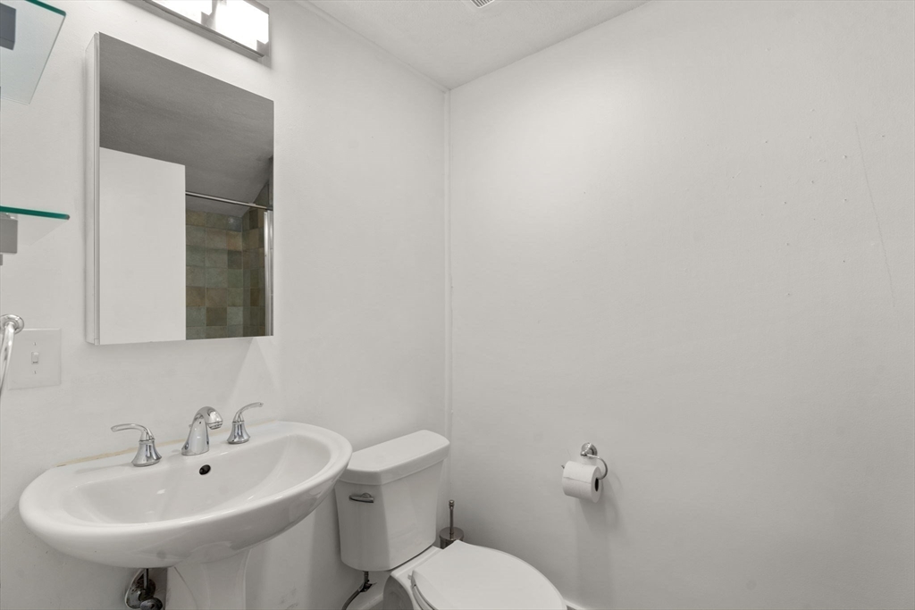 60 Baker Bridge Road Lincoln, MA 01773 - Photo 24 of 38 a bathroom with a sink a mirror and a toilet