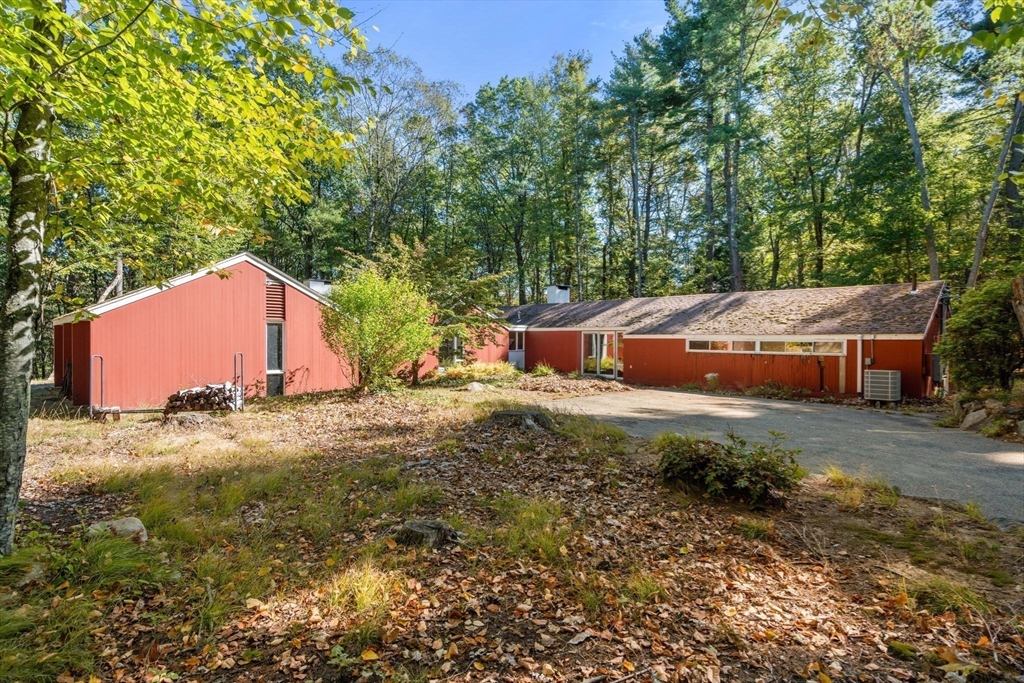 60 Baker Bridge Road Lincoln, MA 01773 - Photo 28 of 38 a backyard of a house with yard and outdoor seating