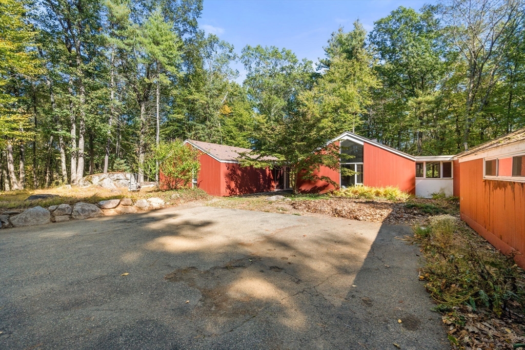 60 Baker Bridge Road Lincoln, MA 01773 - Photo 30 of 38 a front view of a house with a yard