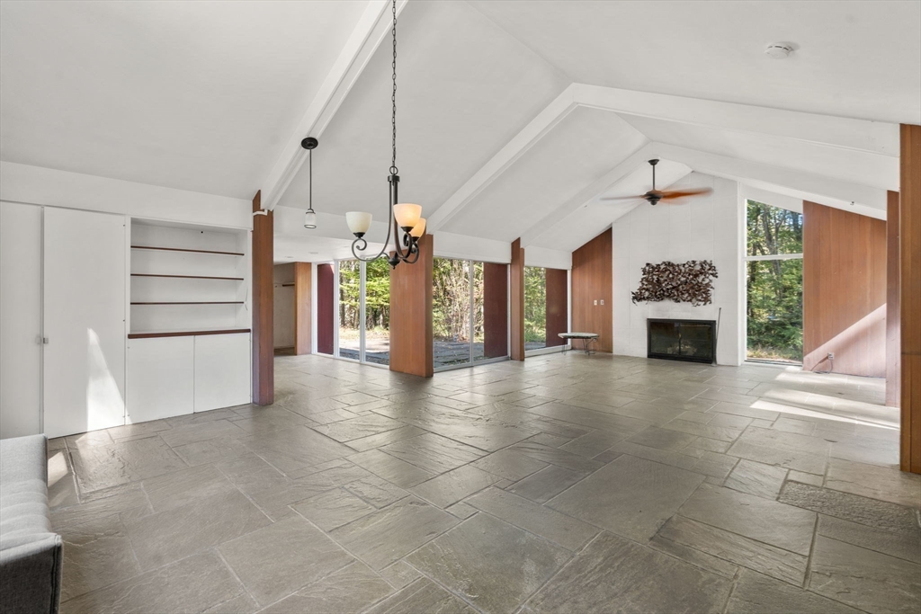 60 Baker Bridge Road Lincoln, MA 01773 - Photo 4 of 38 a view of an empty room with a fireplace and windows