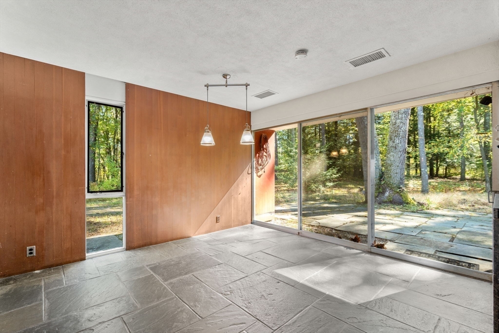 60 Baker Bridge Road Lincoln, MA 01773 - Photo 7 of 38 a view of an empty room with a fireplace and a window