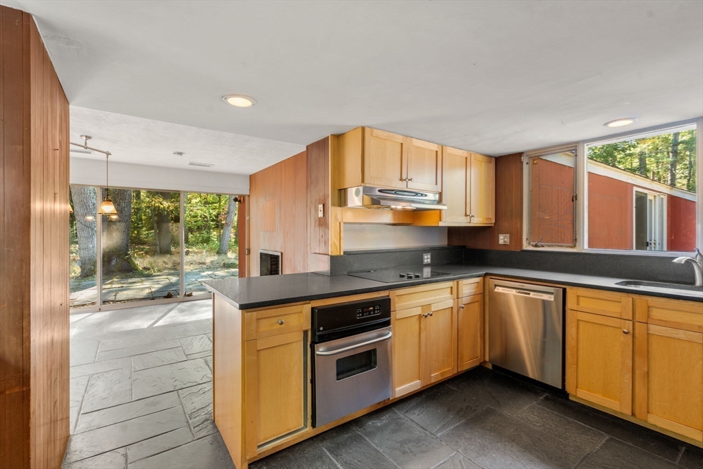 60 Baker Bridge Road Lincoln, MA 01773 - Photo 9 of 38 a kitchen with stainless steel appliances granite countertop a stove and a sink