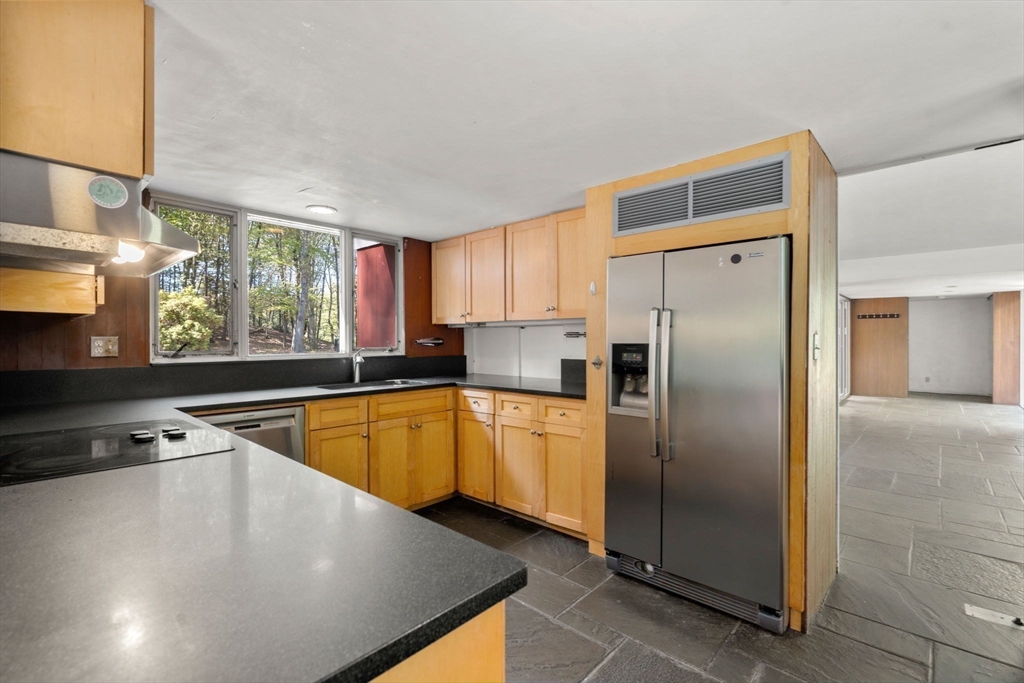 60 Baker Bridge Road Lincoln, MA 01773 - Photo 10 of 38 a kitchen with stainless steel appliances granite countertop a refrigerator a sink and a stove