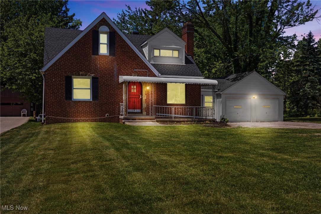 7030 Pearl Road Cleveland, OH 44130 - Photo 2 of 34 View of front facade with a lawn, an outdoor structure, and a garage