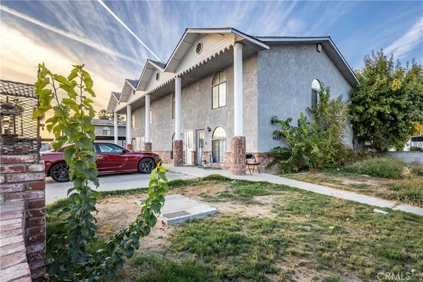 a view of a chair and table in backyard of the house