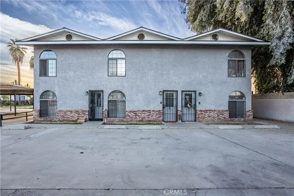 a front view of a house with parking area