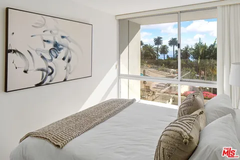 a bathroom with a granite countertop tub sink toilet and a mirror