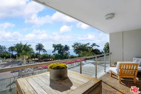 a view of a balcony with chairs