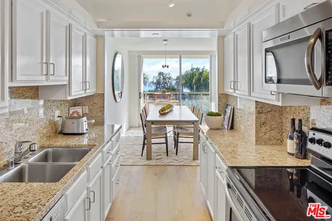 a kitchen with a stove a sink and a refrigerator