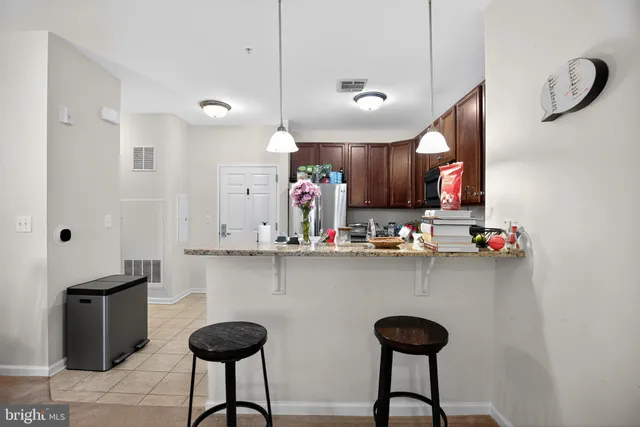 a kitchen with stainless steel appliances granite countertop a refrigerator sink and microwave