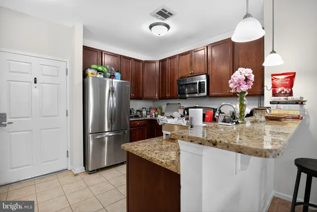 a kitchen with kitchen island a counter space a sink appliances and cabinets