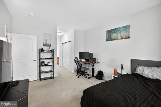 a bedroom with a bed and flat screen tv