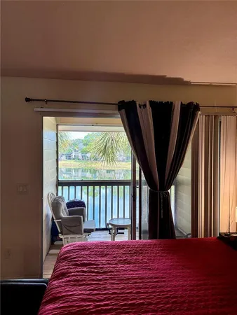 a view of a balcony with chair and wooden floor