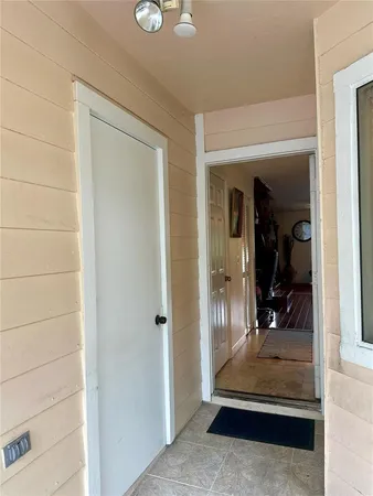a view of front door and a chair