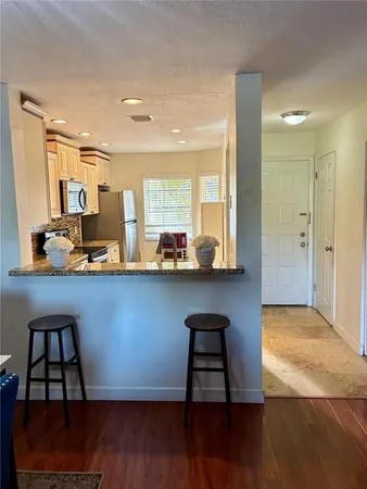 a room with wooden floor and furniture