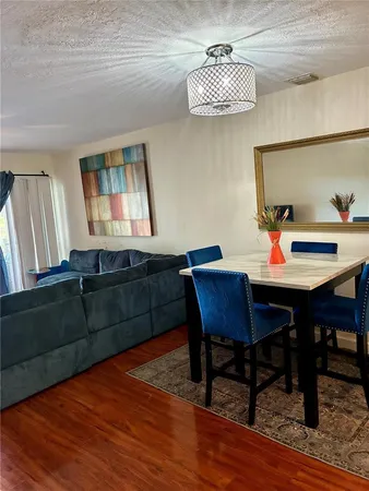 a view of a dining room with furniture and wooden floor