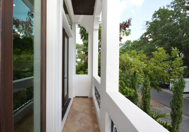 a living room with furniture kitchen view and a window