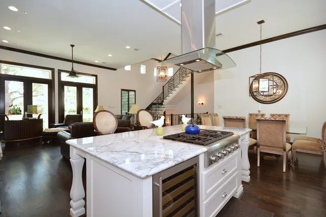 a kitchen with kitchen island a sink stove and refrigerator