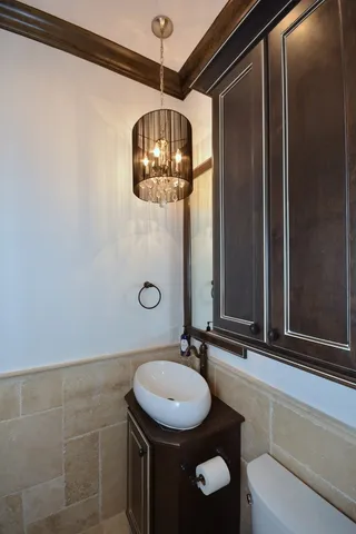 a living room with a table chairs and a clock