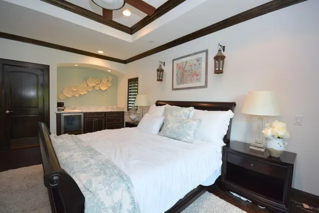 a bedroom with a bed and a chandelier