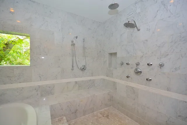 a bathroom with a bathtub and shower