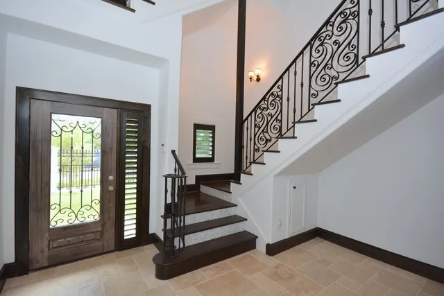 a view of entryway with wooden floor and stairs