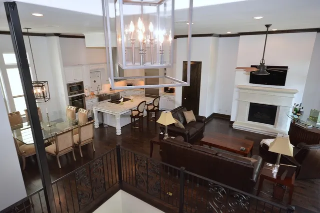 a living room with furniture a fireplace and a chandelier