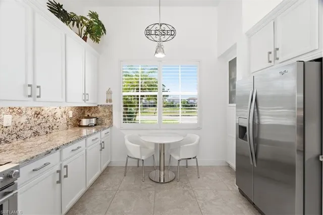 a kitchen with stainless steel appliances a refrigerator sink and cabinets