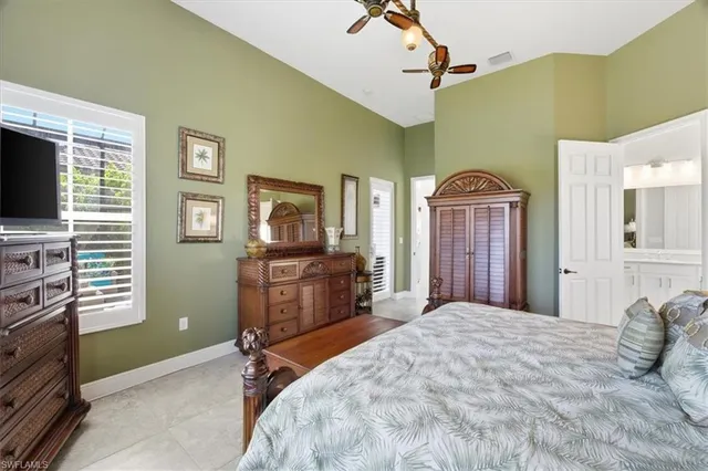 a bedroom with a bed dresser and a flat tv screen
