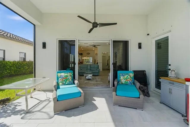 a living room with furniture and a pool table