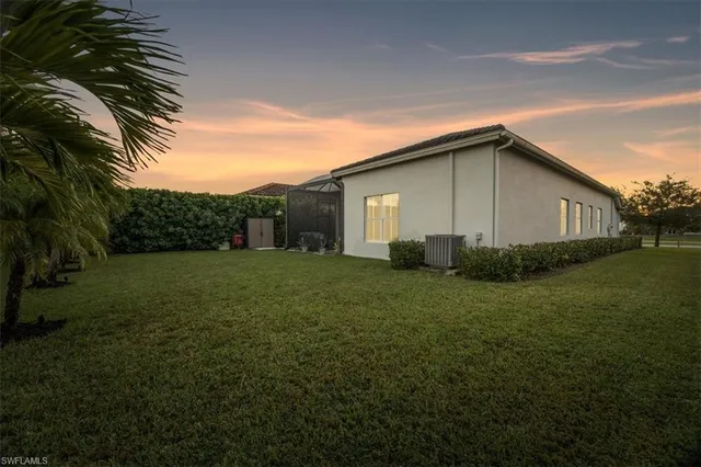 a view of backyard of house with green space