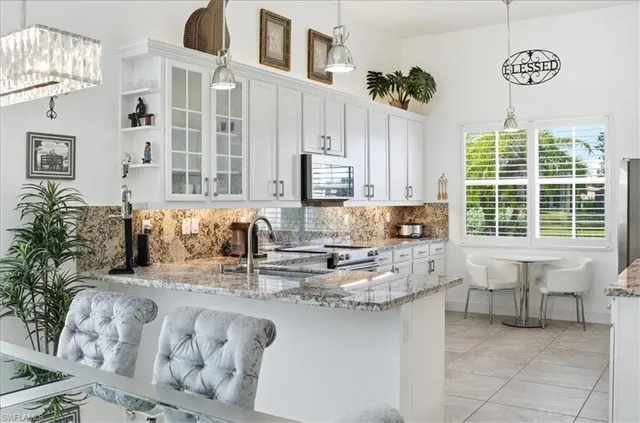 a kitchen with stainless steel appliances granite countertop a sink and a cabinets
